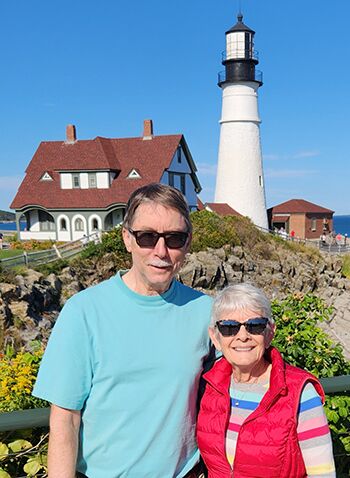 A couple in front of a lighthouse