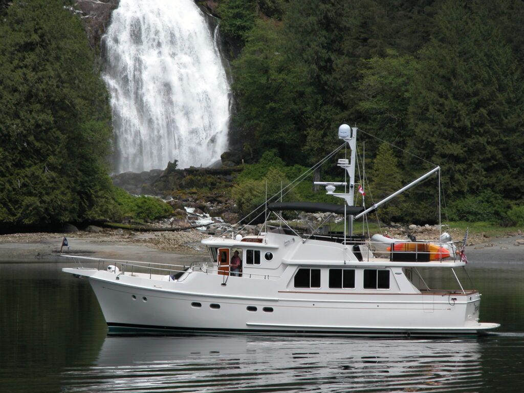 Yacht in front of a waterfall in Alaska