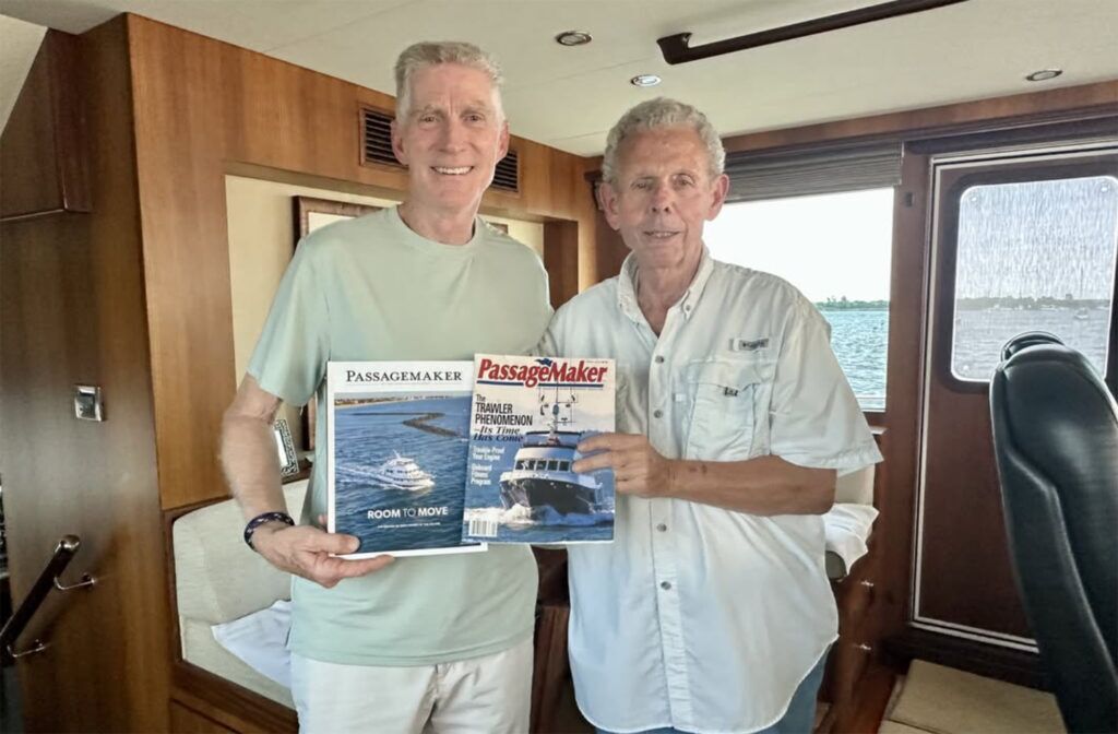 Two men posing with magazines