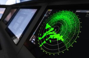Radar screen with green display indication on a captains bridge of modern ship