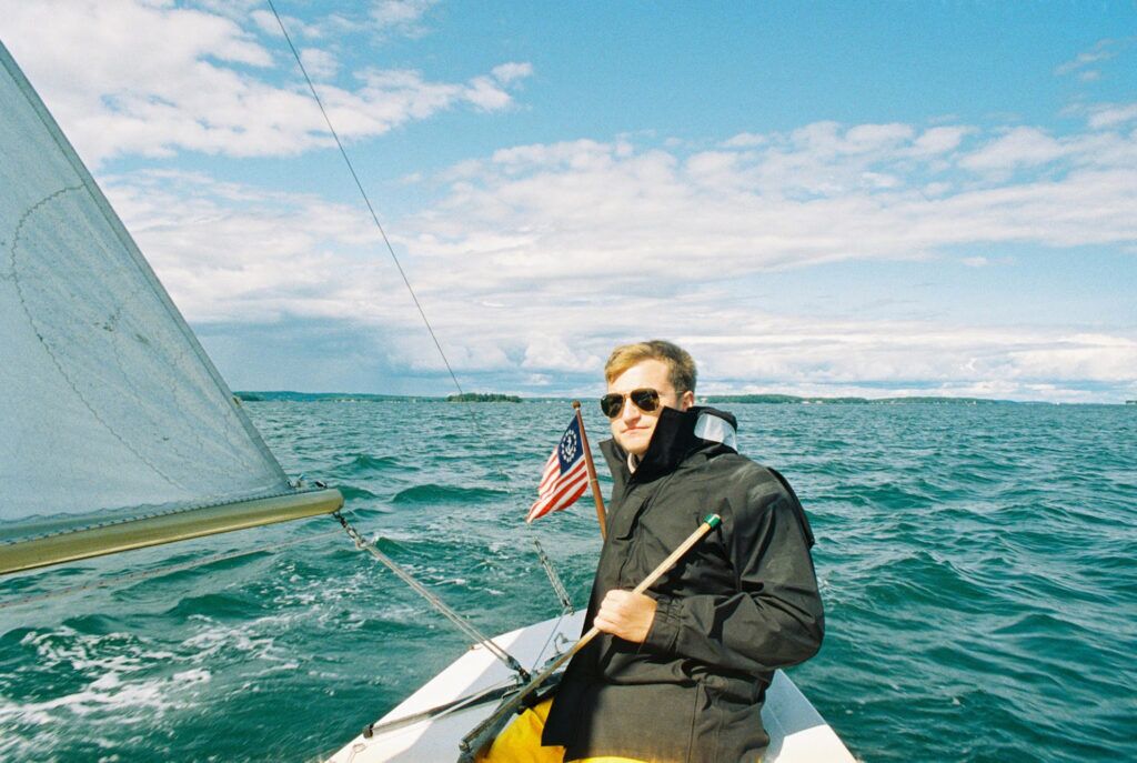 Young man in a small sailboat